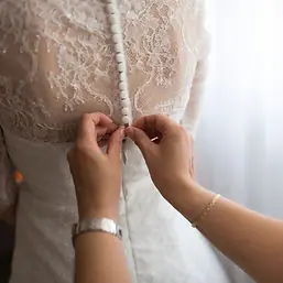 Close up of the lace back and buttons of a bridal gown
