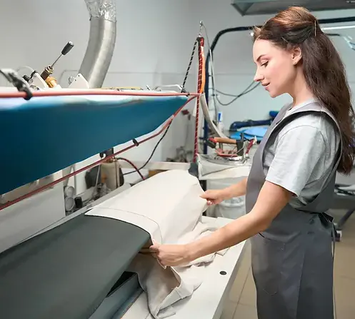 A CleanMeNow team member handling household linens in Draper, Utah